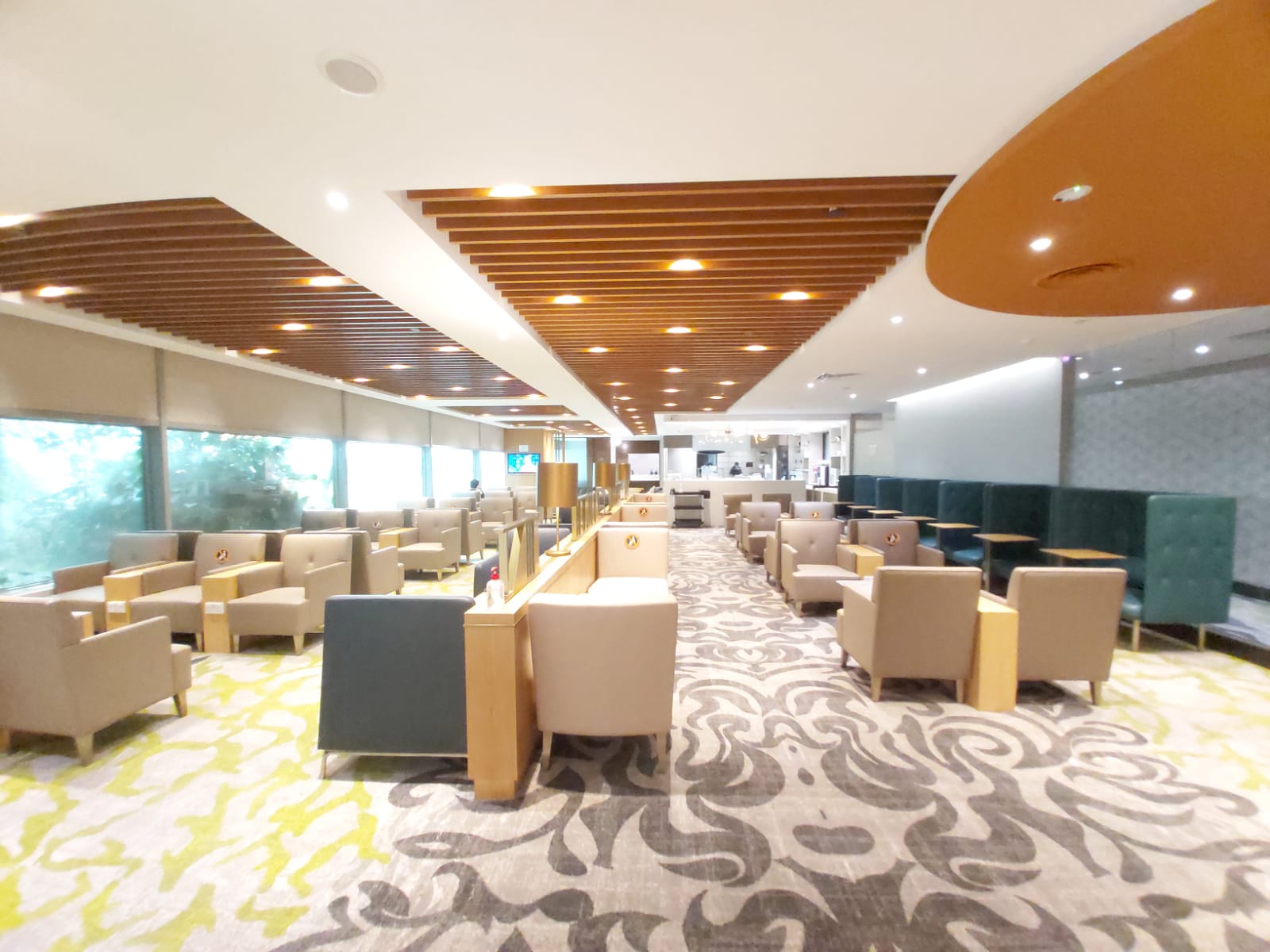 Armchairs and booth seating inside the Ambassador Transit Lounge at Changi Terminal 3