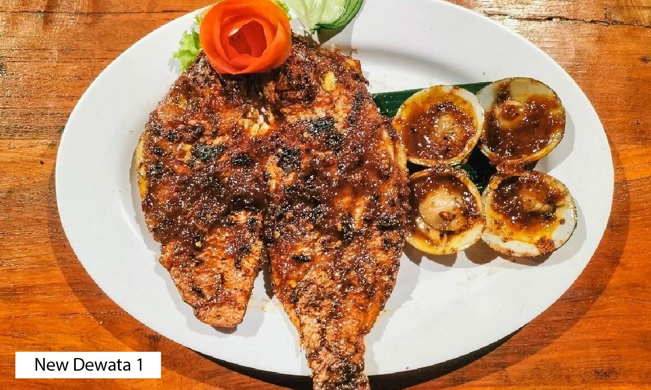 Seafood dinner set up at tables on the beach in Jimbaran, Bali