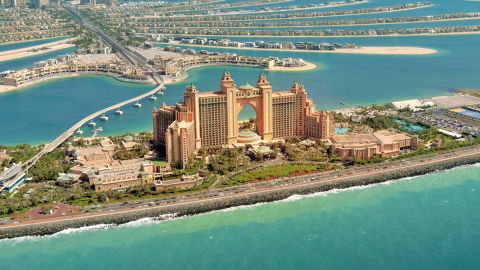Aerial view of Atlantis The Palm hotel and the fronds of Palm Jumeirah surrounded by turquoise sea