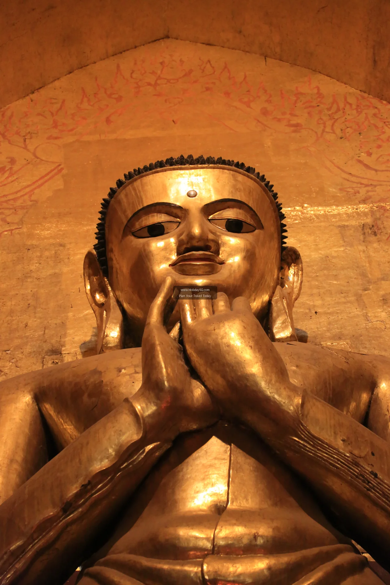 One of the gilded standing Buddha images inside Ananda Temple in Bagan