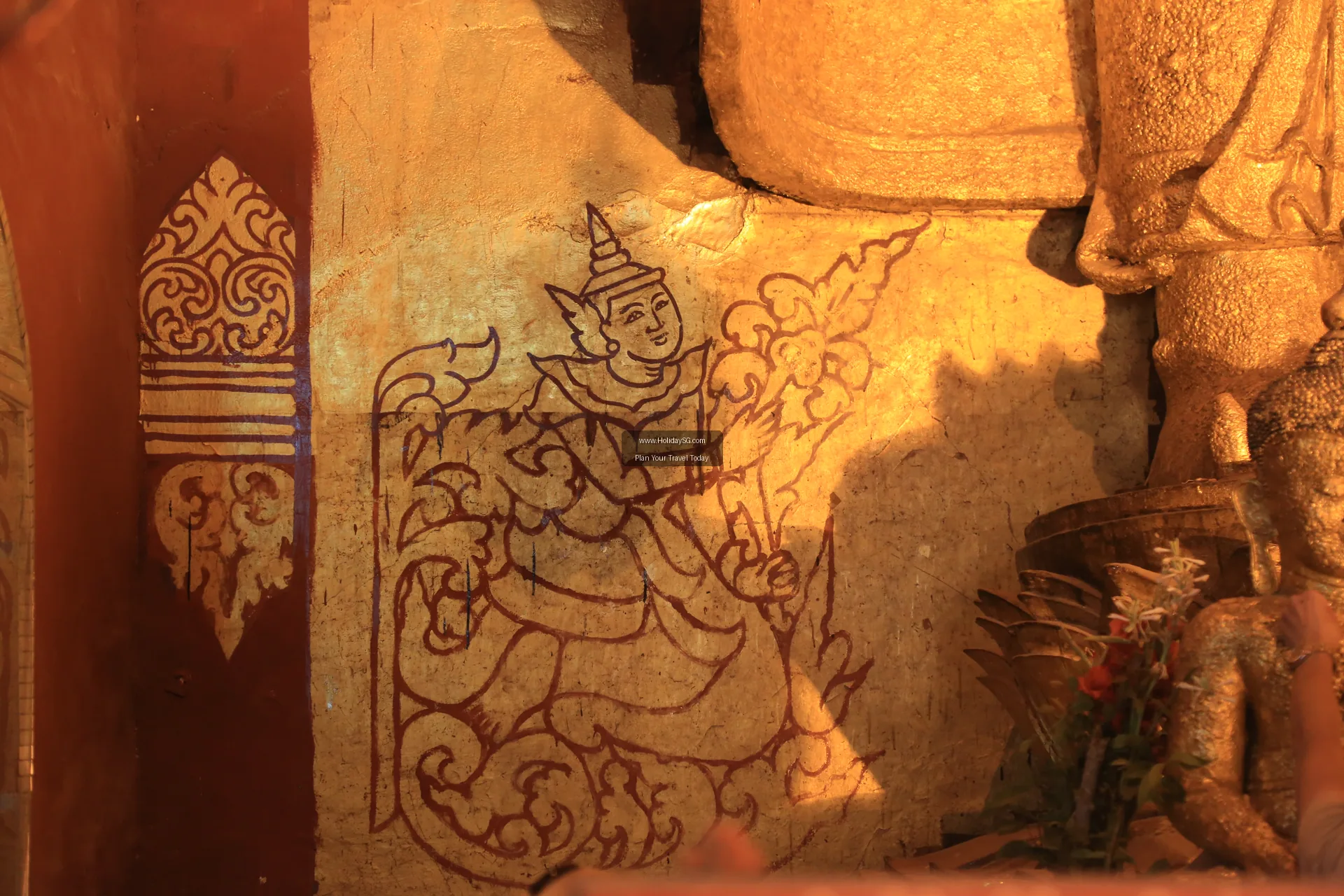 Visitors walking along the outer corridor of Ananda Temple in Bagan