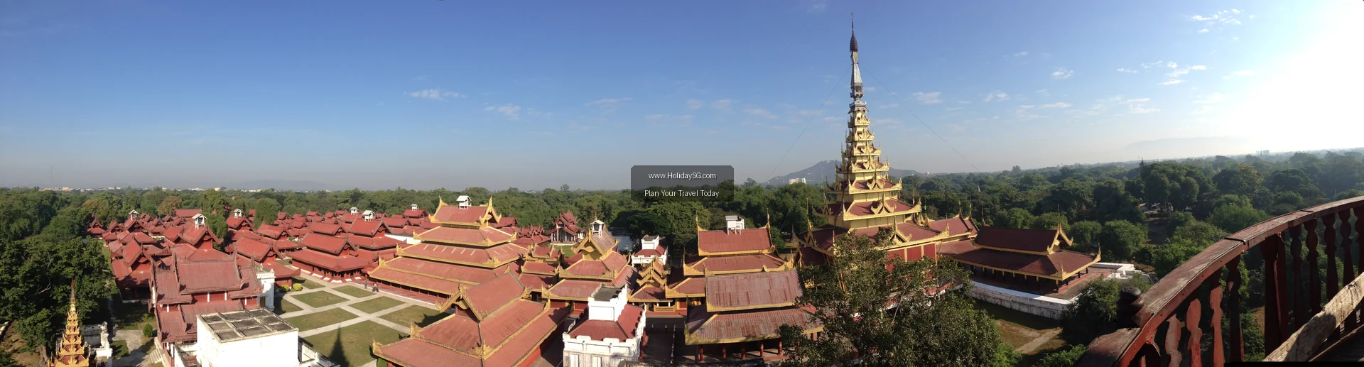 Rebuilt palace buildings with tiered red and gold roofs inside Mandalay Palace